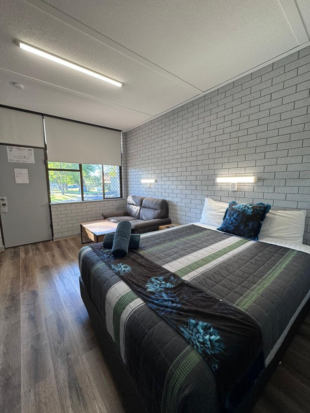 Standard Queen Room with feature brick wall and double bed
