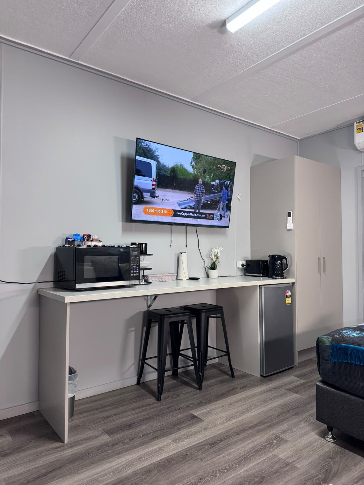 Standard Queen Room kitchenette with smart TV